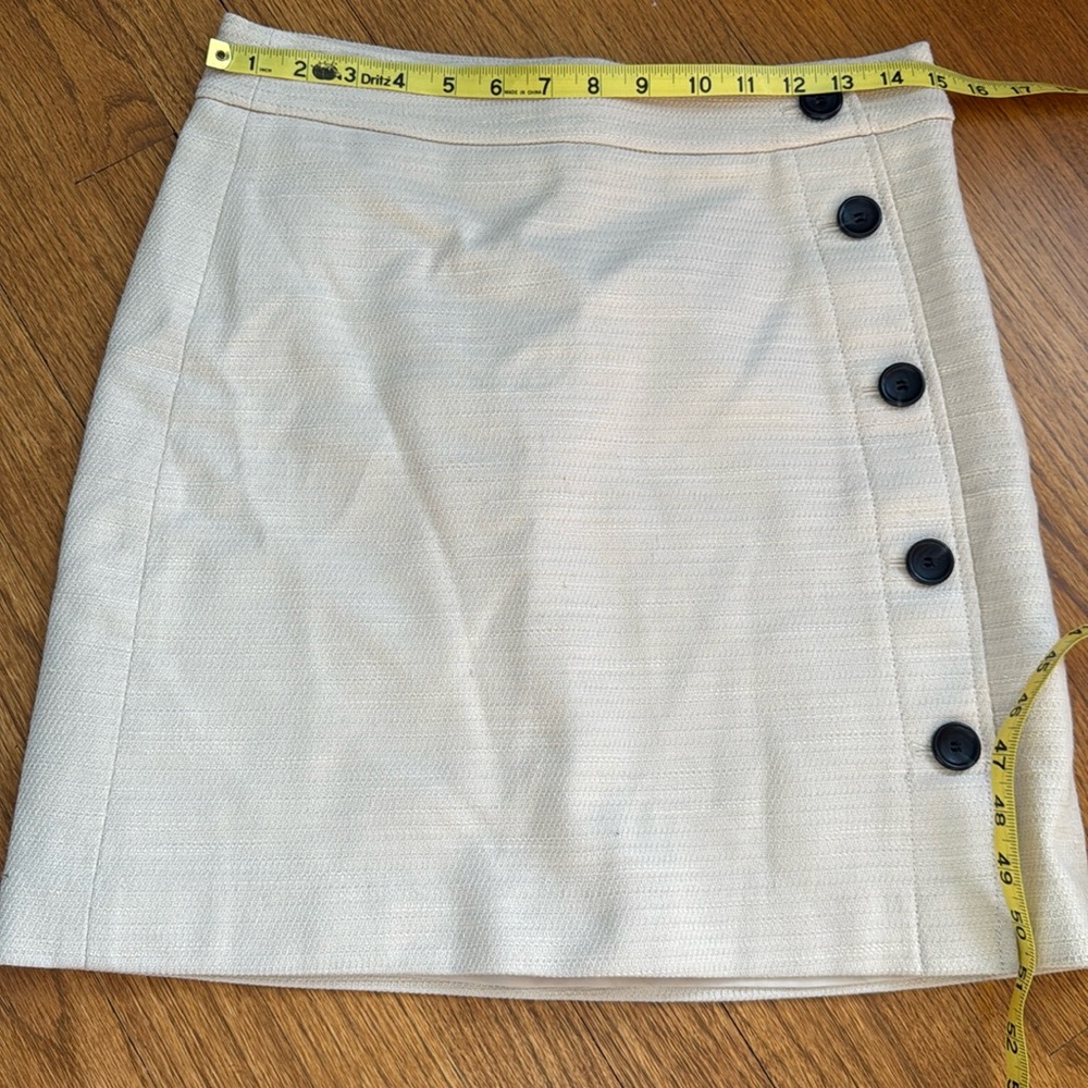 Ann Taylor size 4, cream mini skirt with buttons.